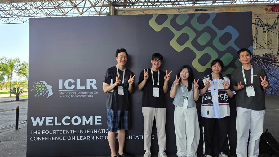 ML3 members posing together beside the ICLR conference welcome sign.